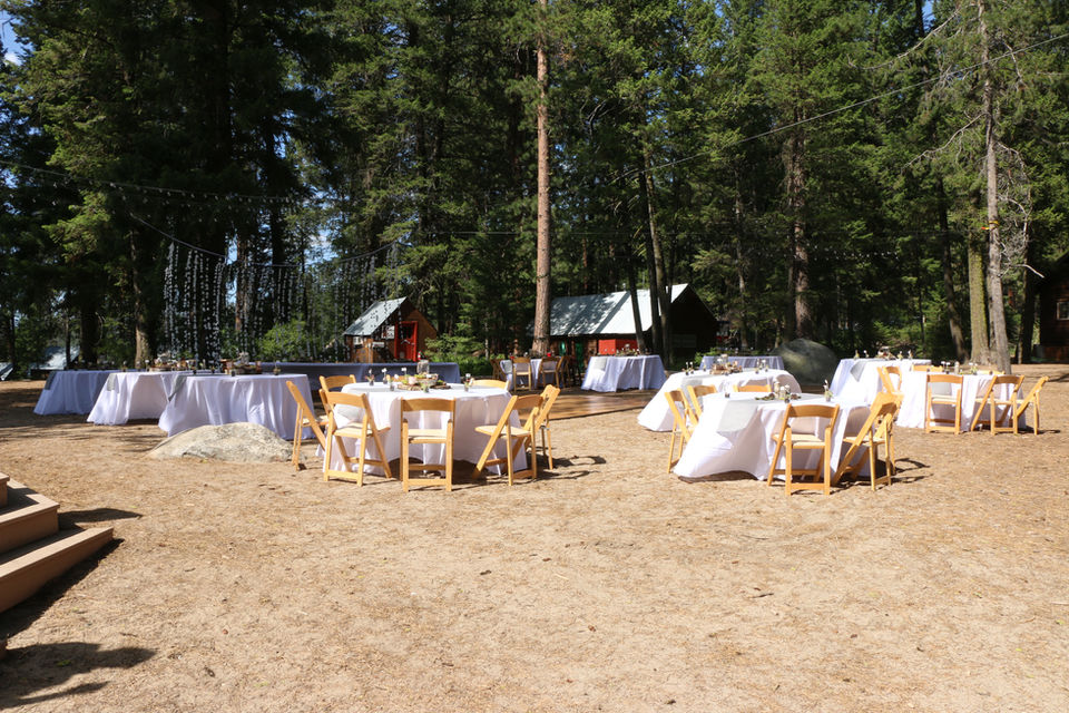 Wedding reception area set with tables in white tablecloths.
