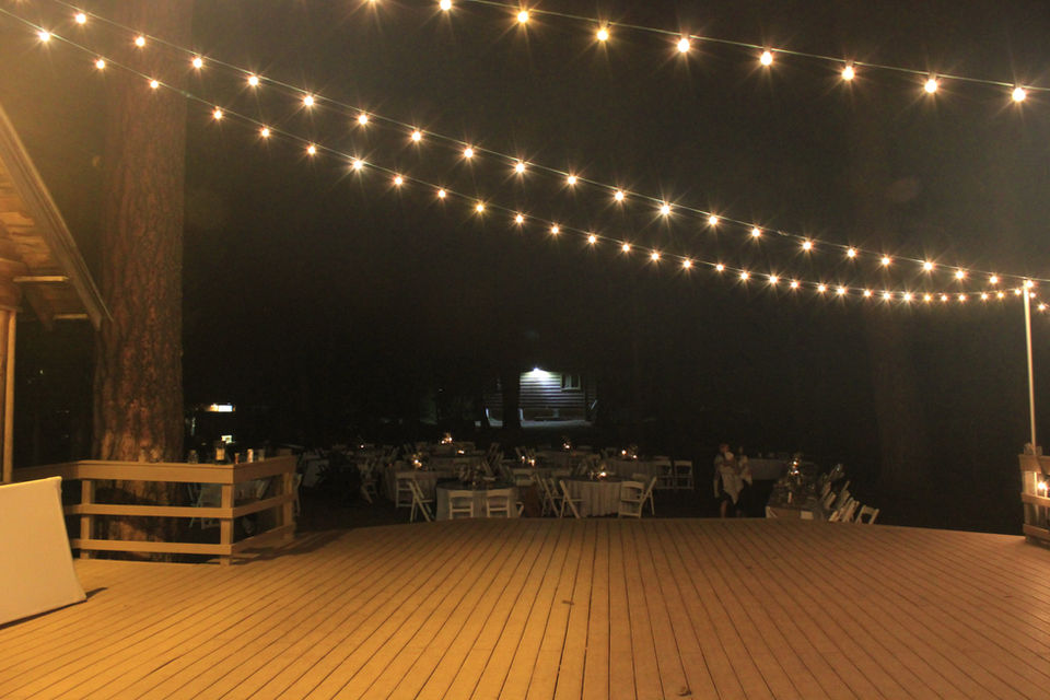 Dining Hall deck set for reception celebration with bistro lights.