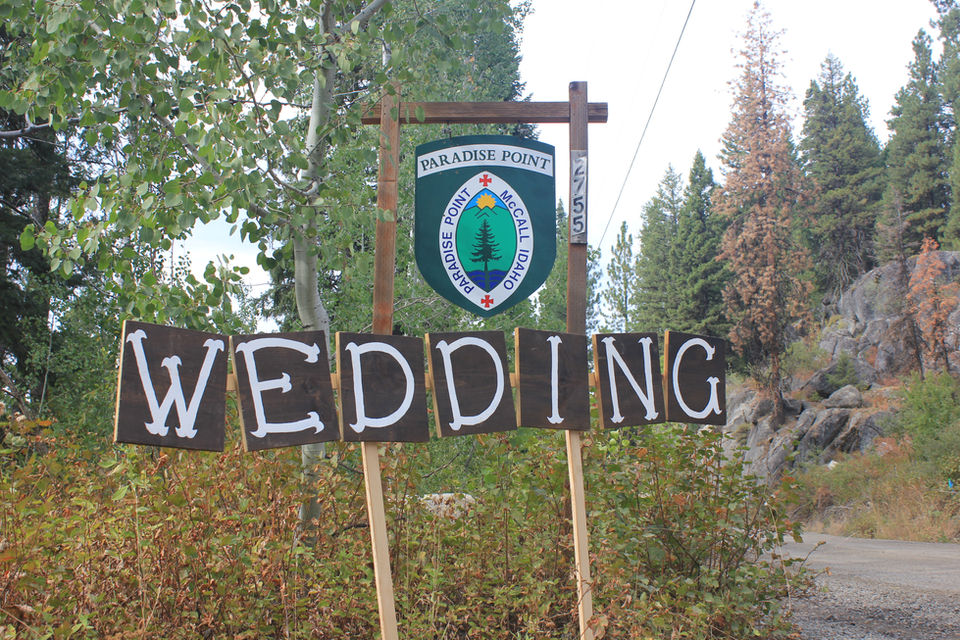 Rustic "wedding" sign is set up below Paradise Point Camp's entry sign on Eastside Drive. 